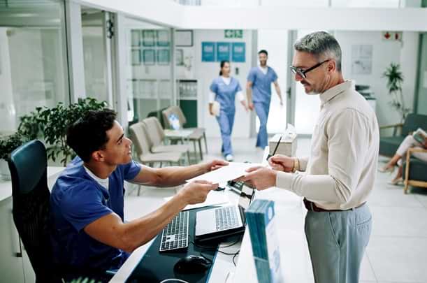 Hospital, nurse and man at front desk with paperwork for appointment, consultation and medical service. Healthcare, clinic and mature patient with admin for insurance, application form and documents.