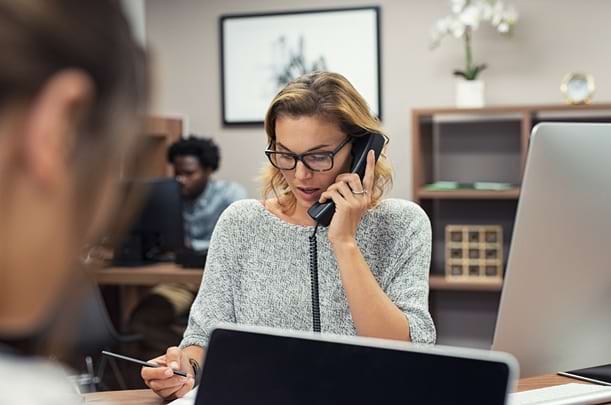 Business woman talking on phone at office