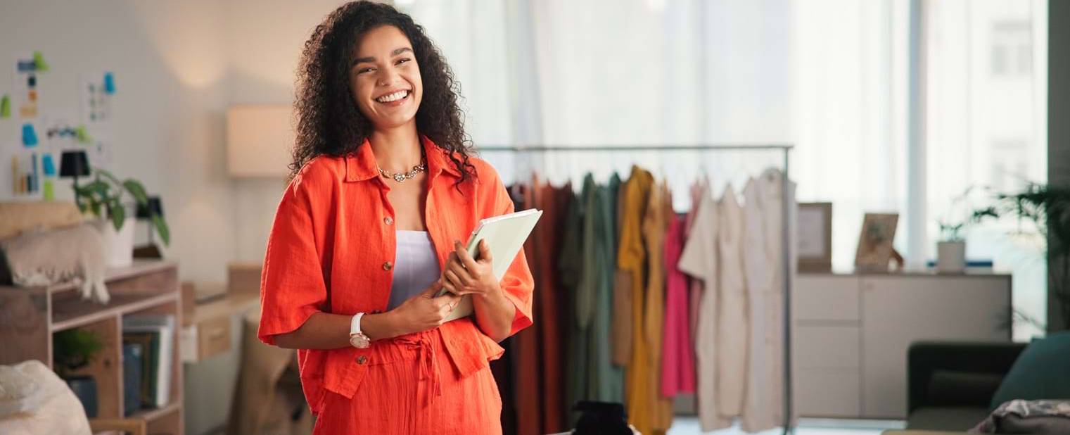 Business, fashion designer and woman with portrait, tablet and smile with ecommerce. Person, entrepreneur and store owner with tech, online order and website info for company, boutique shop or sales.