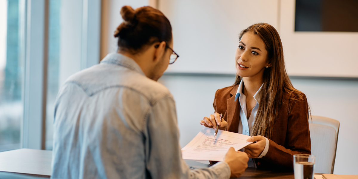 A close-up of an HR advisor guiding an employee through a workplace policy, reflecting the support-oriented aspect of HR work in Ireland.