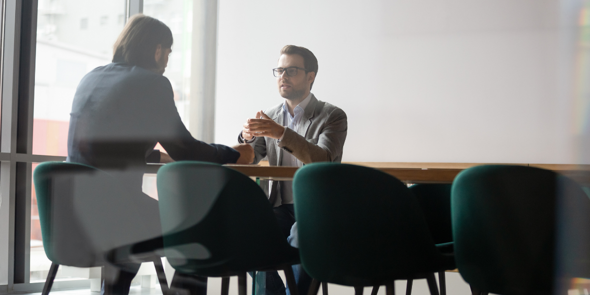 A close-up of an HR manager assisting an employee with workplace concerns, showcasing the collaborative nature of HR work in Ireland.