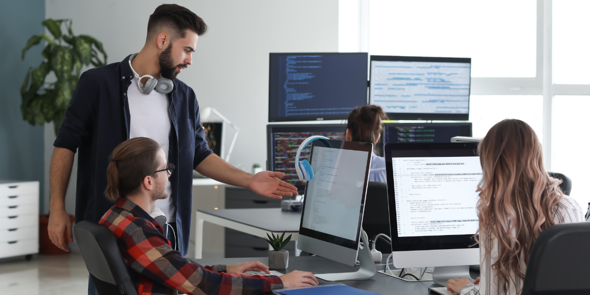 A focused IT team collaborating on website development, highlighting the web design and programming expertise available through IT career training in Wexford.