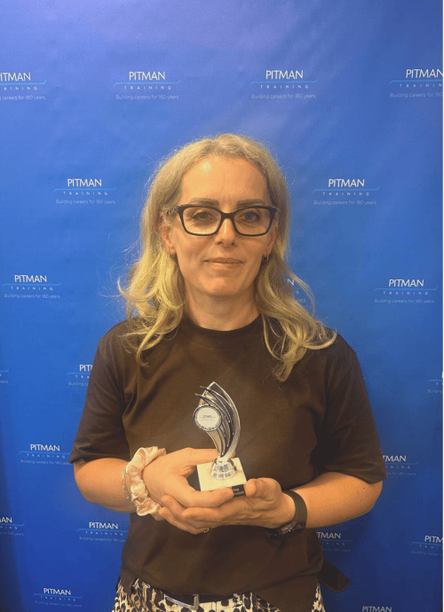 Ola holding Student of the Month award at Pitman Training after completing an Excel course, August 2025