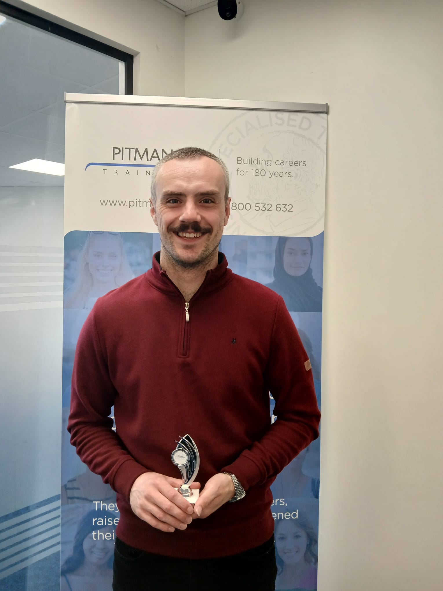 Cormac Fox receiving Student of the Month award at Pitman Training Carlow May 2026.