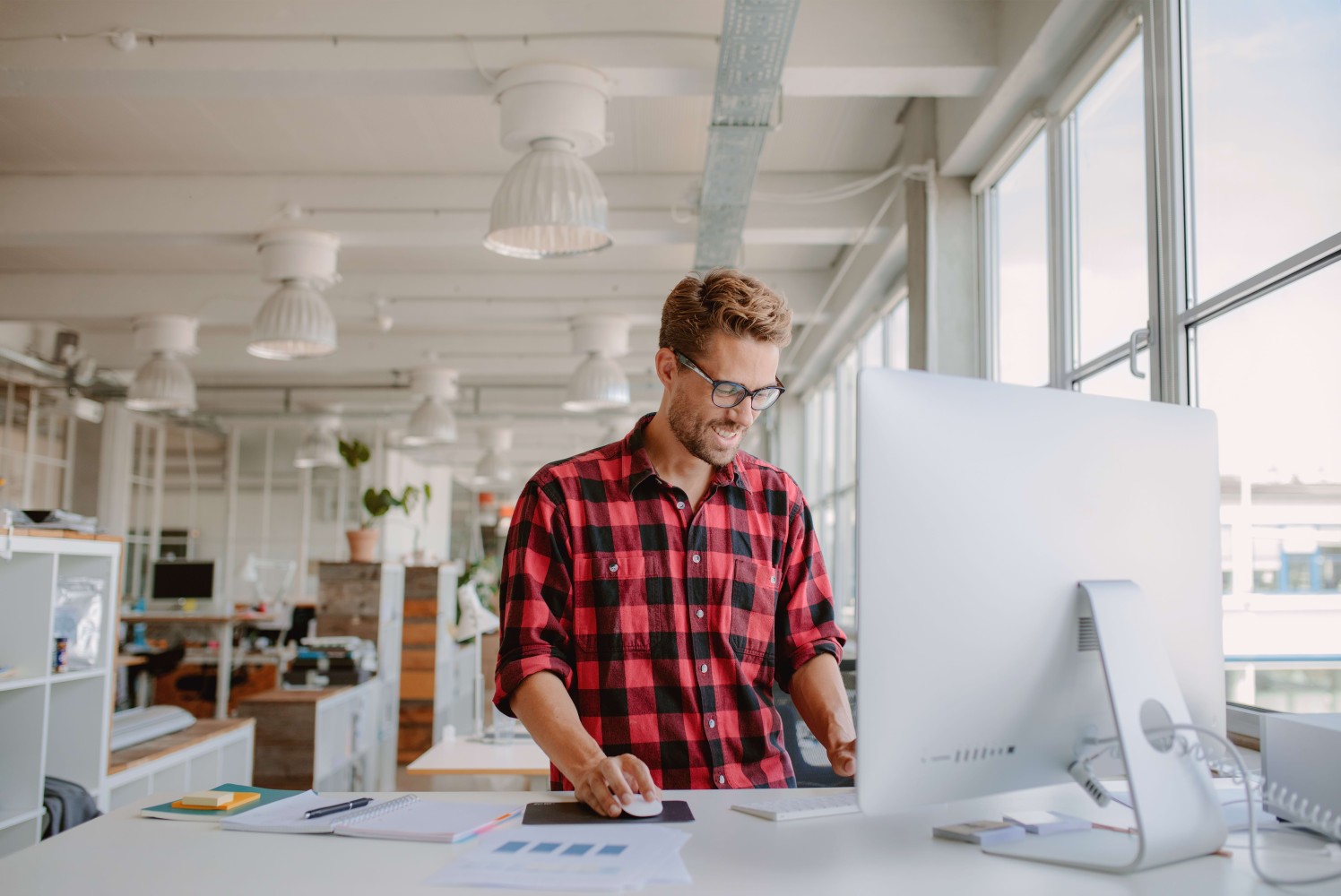 Professional building practical workplace skills at a standing desk — Pitman Training professional development courses
